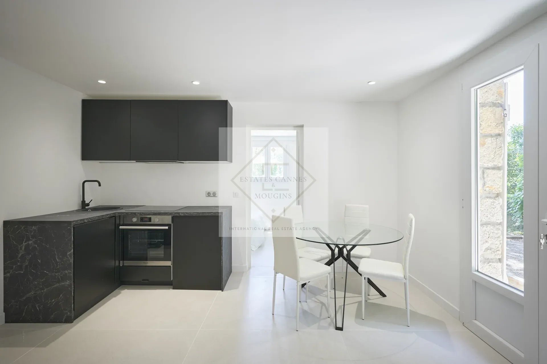 Modern kitchen with dining table and chairs in a villa in Mougins.