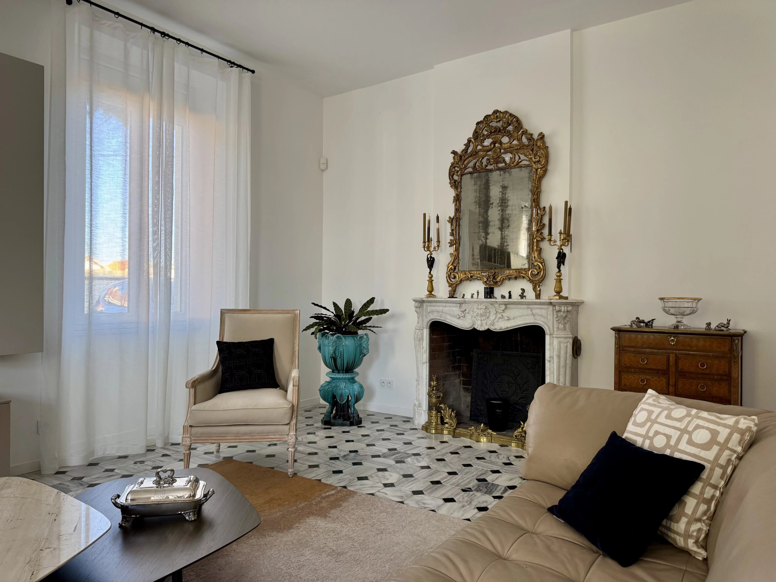 Interior of a renovated country house with fireplace and elegant furniture in Marseille.