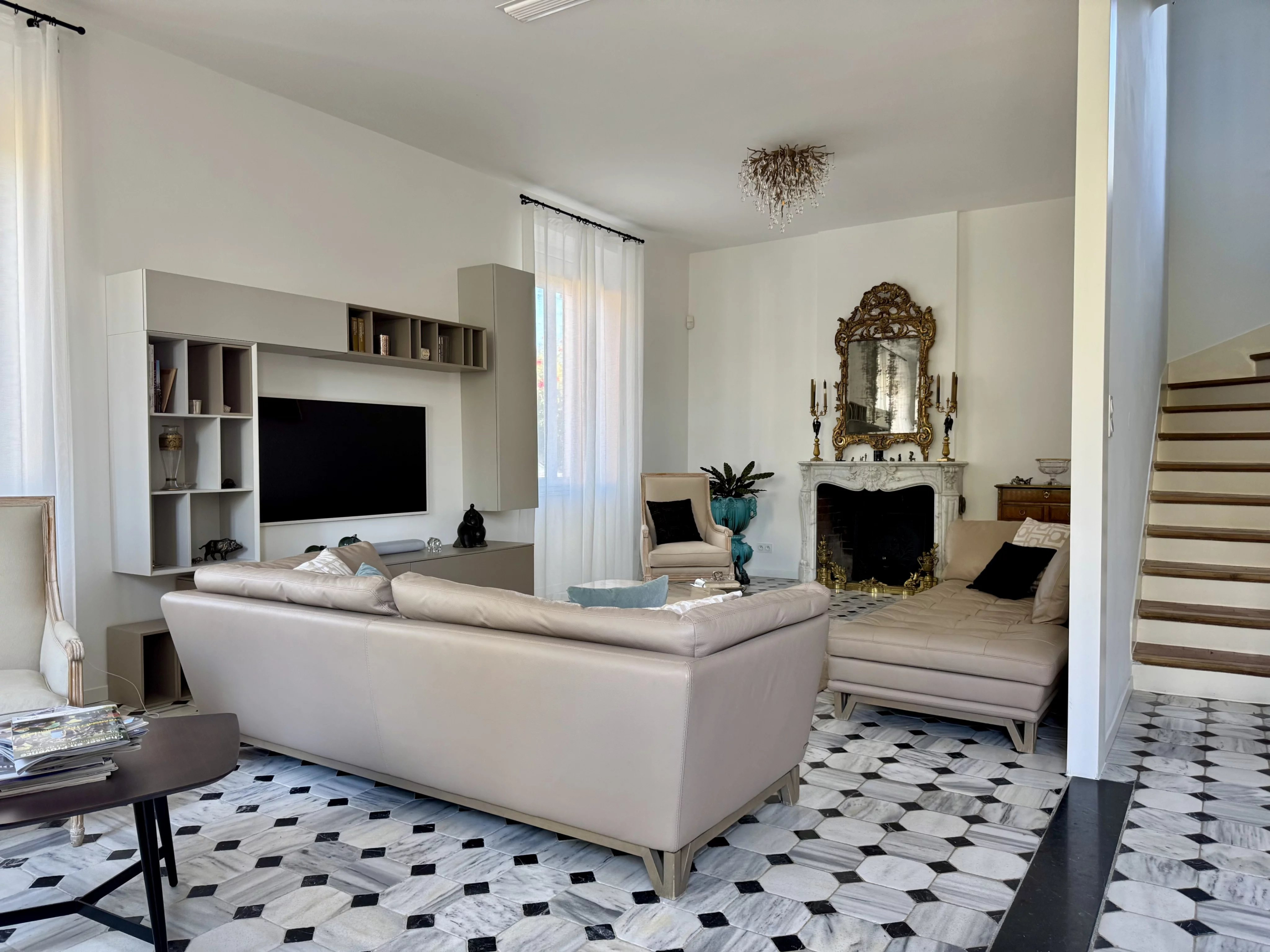 Interior of a renovated bastide with modern living room, fireplace and elegant decoration in Marseille.