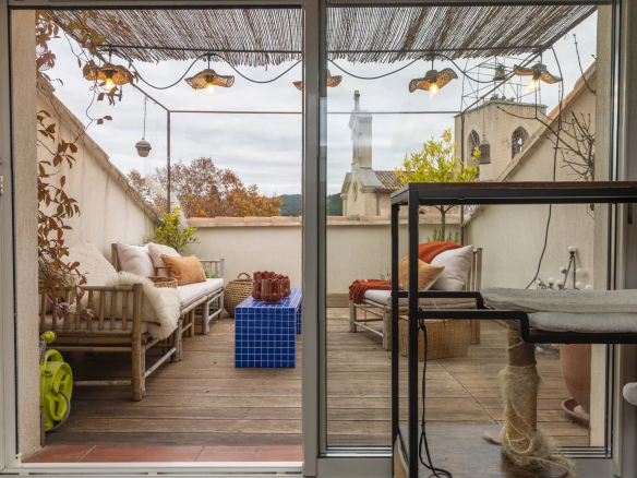 Terrace of a building in Saint-Cyr-sur-Mer with cozy furniture and decor.