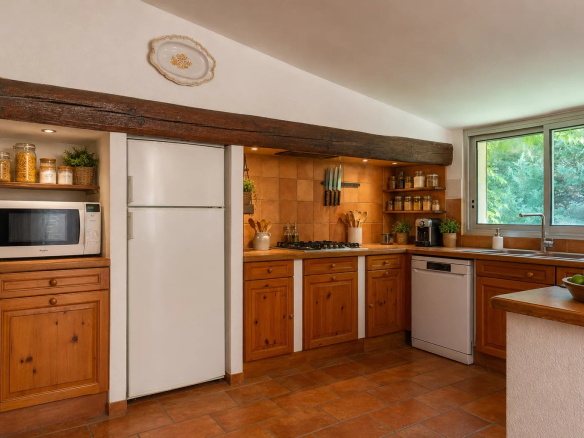Kitchen in a property in Fourques with wooden furniture and modern equipment.