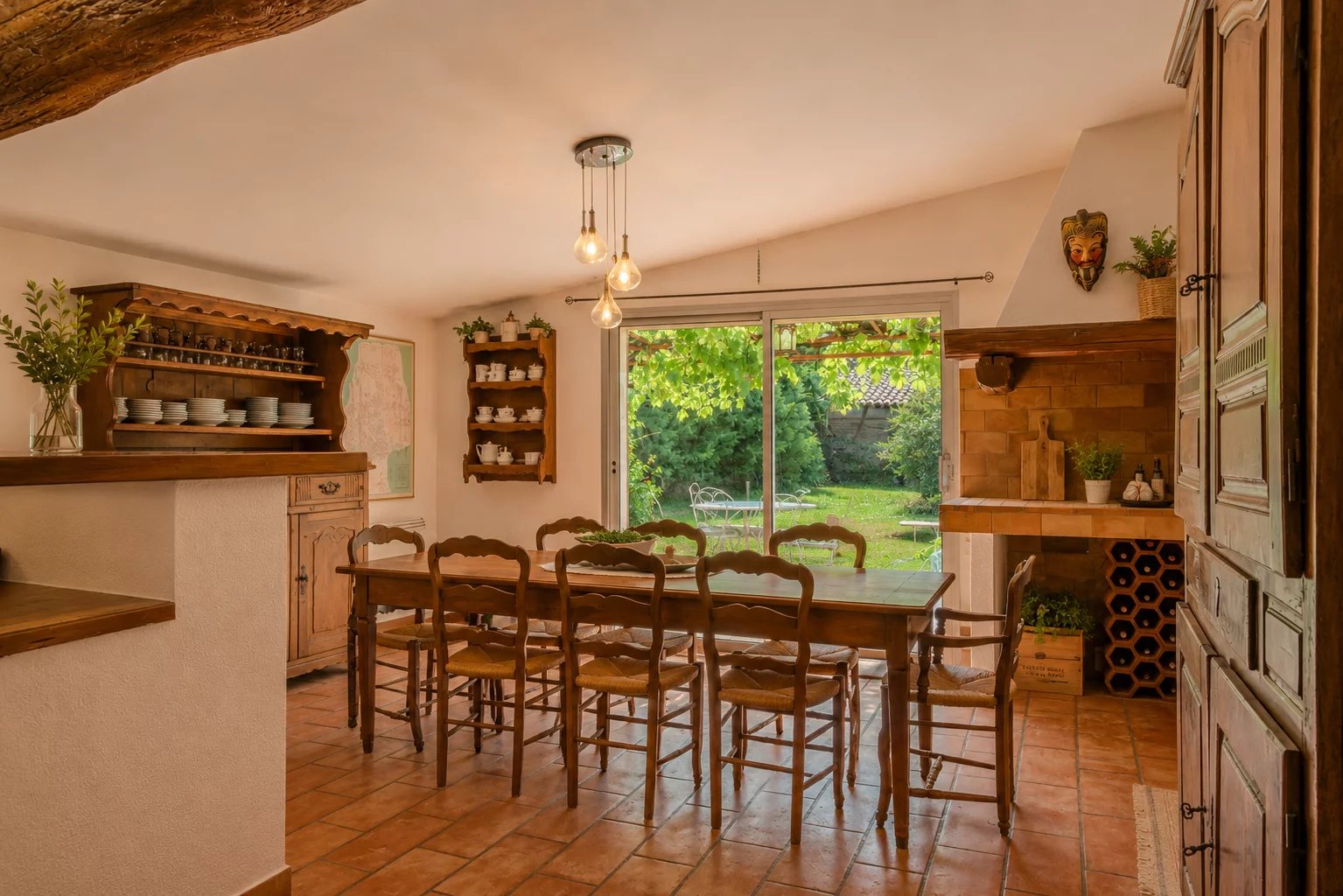 Dining room with garden view Interior of a dining room with a large wooden table and a view of a garden.