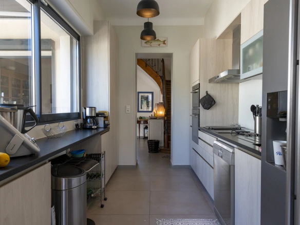 Cuisine moderne et lumineuse d'une villa à Marseille, avec vue sur la mer.