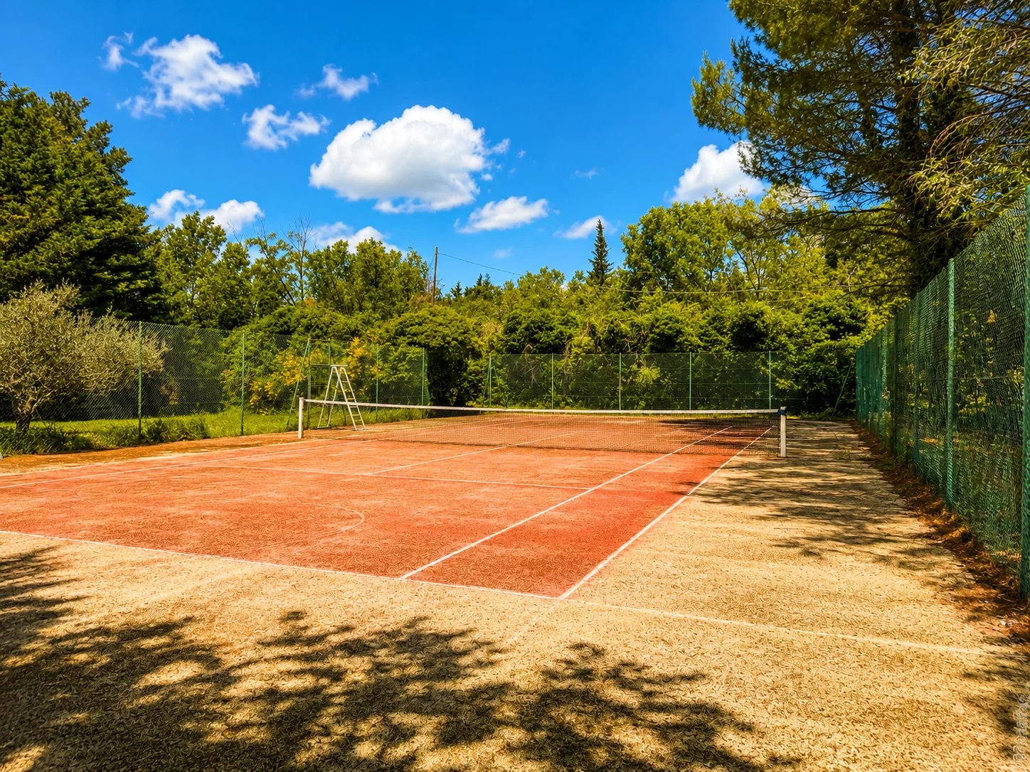 Tennis courts in a green park near Orgon, Provence.