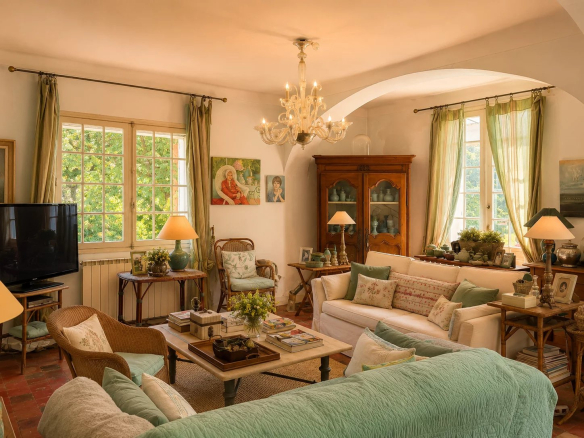 Interior of a bright living room with comfortable sofas and Provençal decorations.