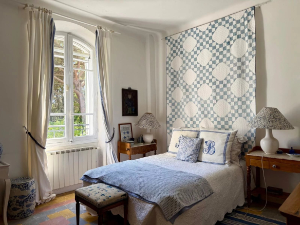 Room in a property with Provençal decor, windows overlooking a garden.