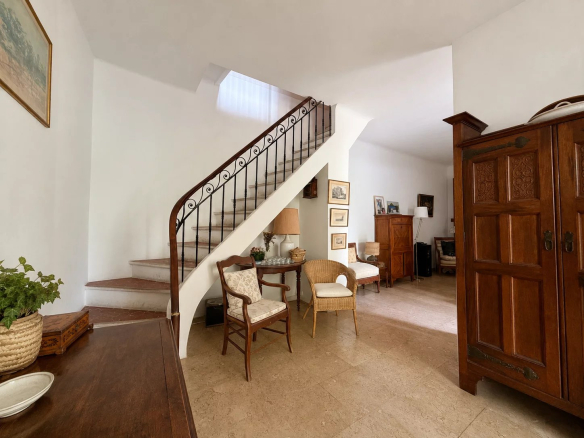 Interior of a house for sale with staircase, wooden furniture and bright living room.