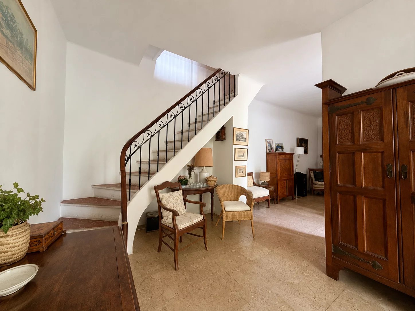 Interior of a house for sale with staircase, wooden furniture and bright living room.