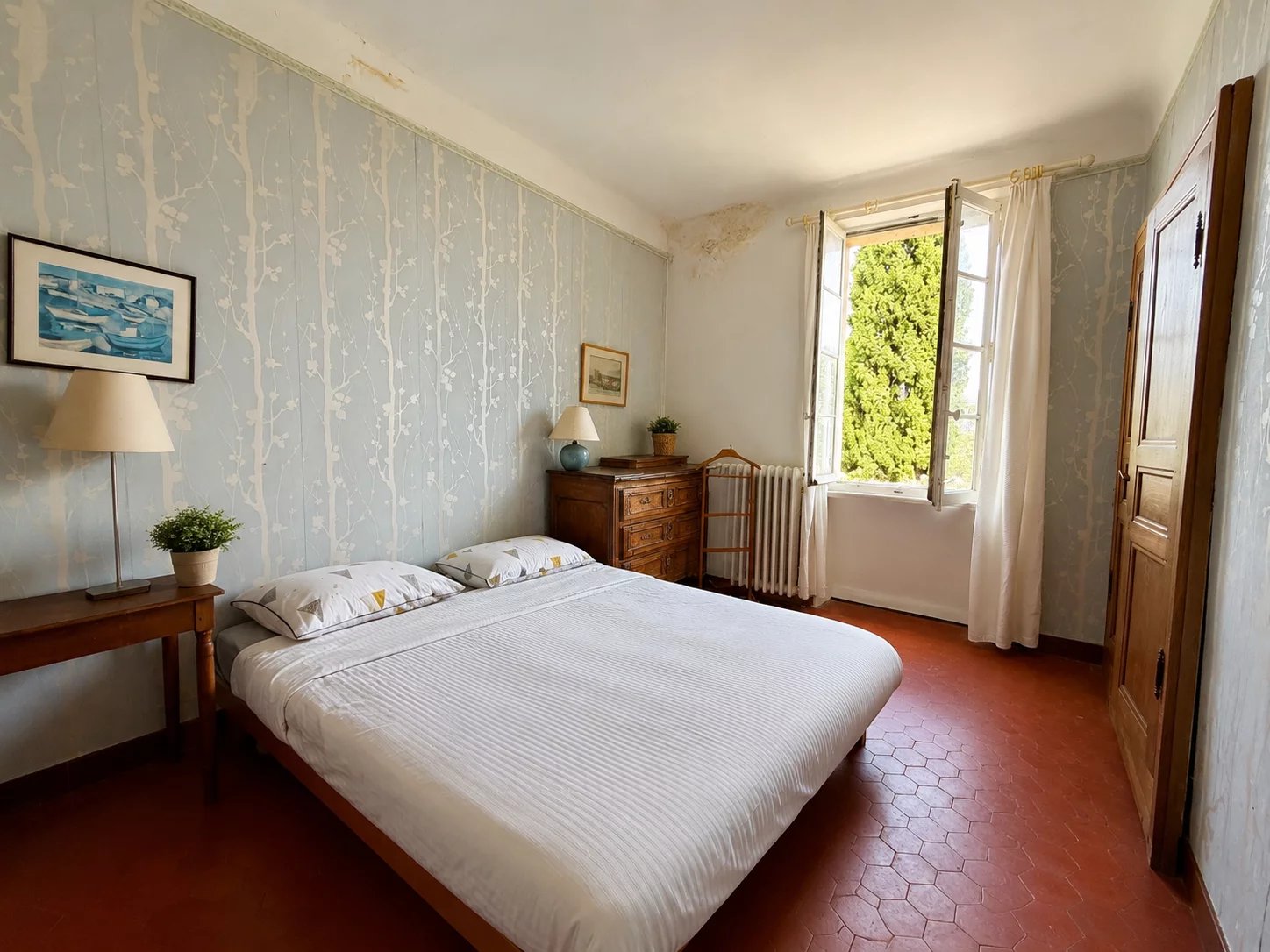 Room in a house for sale in Marseille 8th arrondissement, with bed, open window and wall decoration.