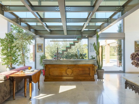 Interior of a modern architect-designed villa with a wooden bar and plants, Bouc-Bel-Air.