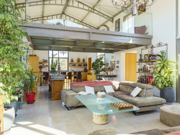 Interior of a modern architect-designed villa with a spacious living room and open-plan kitchen.