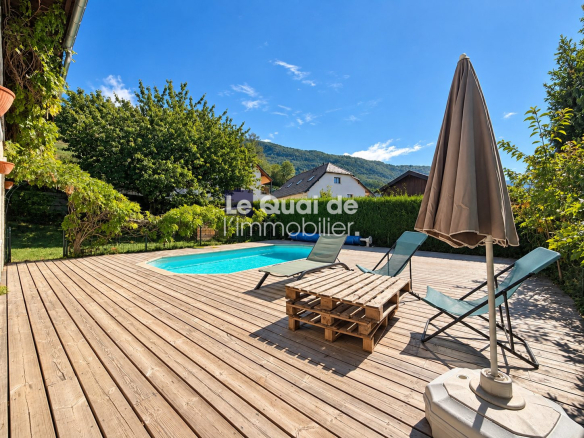 Wooden terrace with swimming pool and sun loungers in Nâves-Parmelan