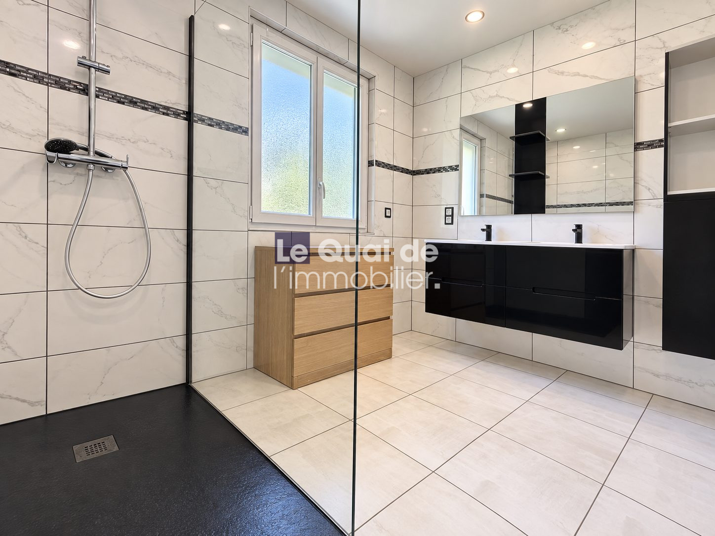 Modern bathroom with shower and wooden furniture in Nâves-Parmelan.