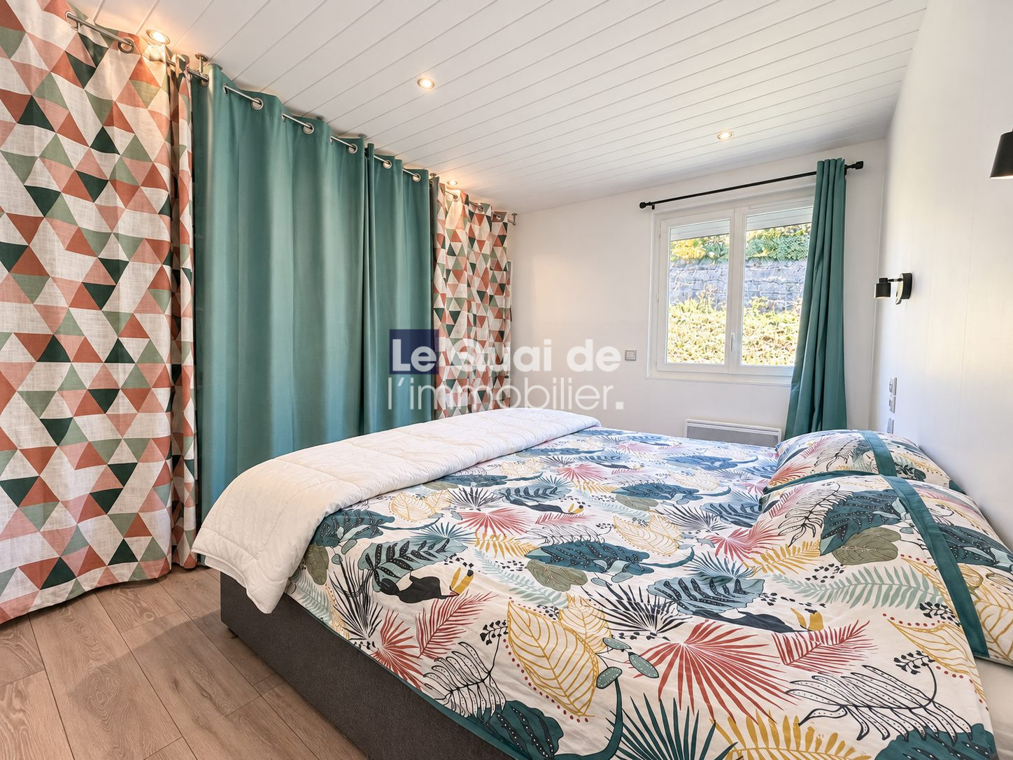Room in a house for sale in Nâves-Parmelan, decorated with colorful patterns.