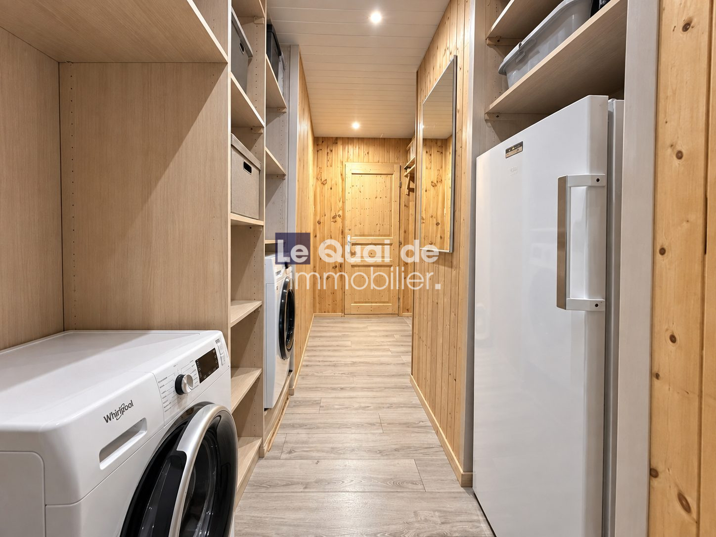 Interior of a house in Nâves-Parmelan with laundry room and storage.