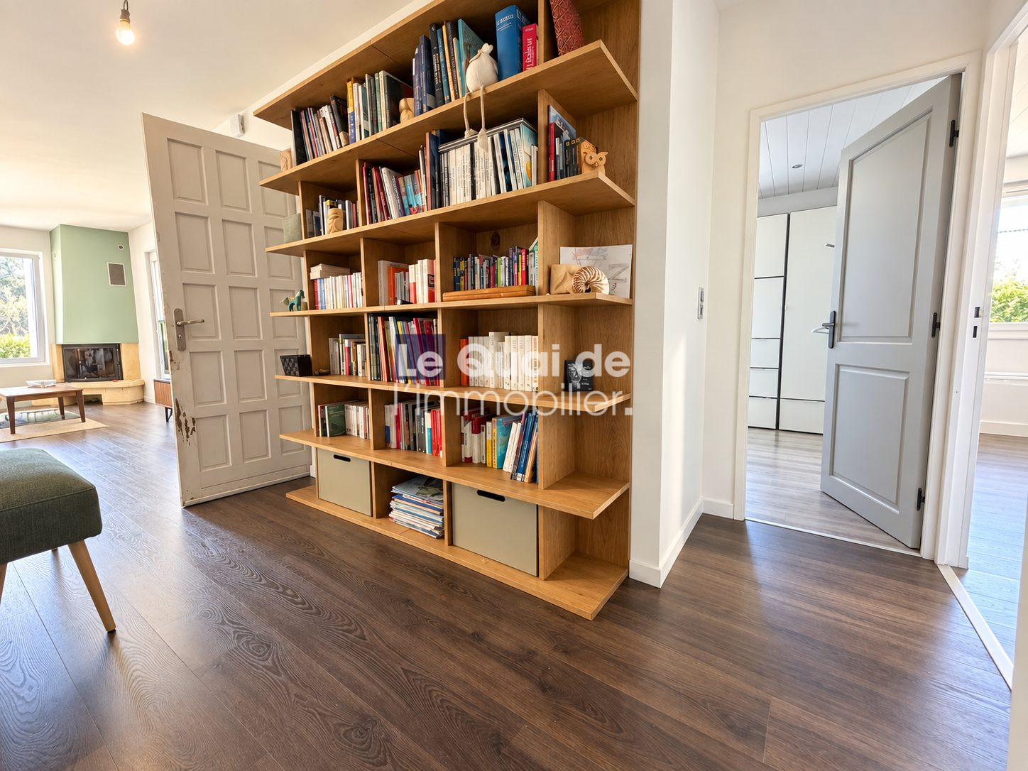Interior of a house for sale in Nâves-Parmelan, with a wooden bookcase and parquet flooring.