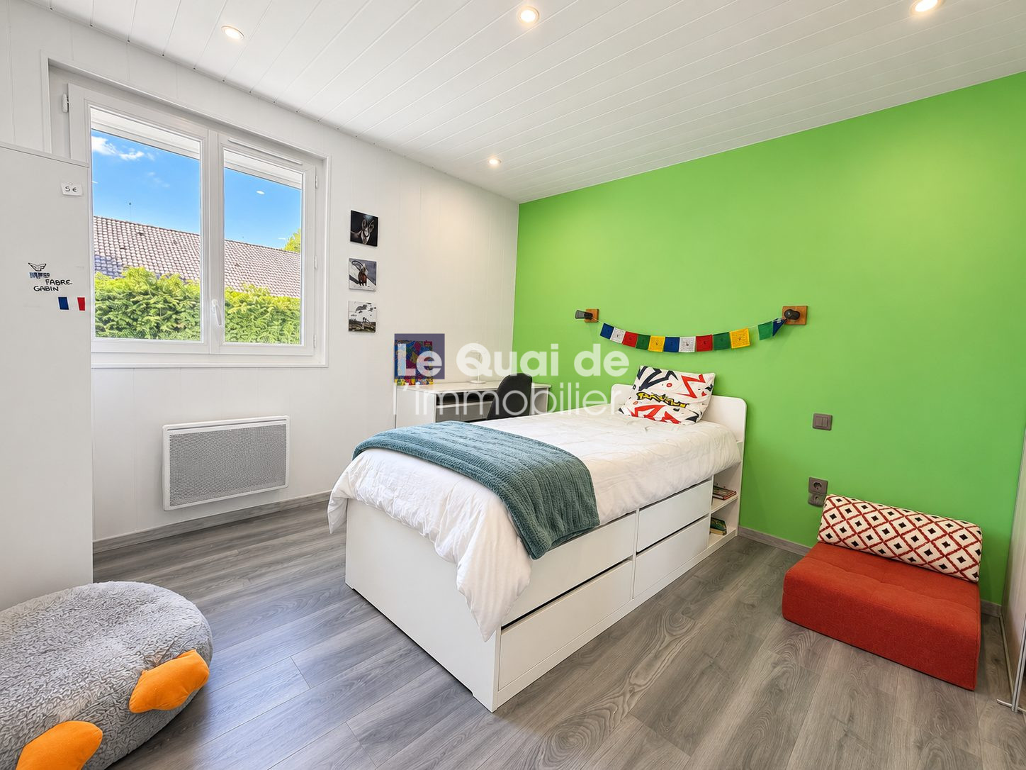 Room in a house for sale in Nâves-Parmelan, with a single bed and colorful decoration.