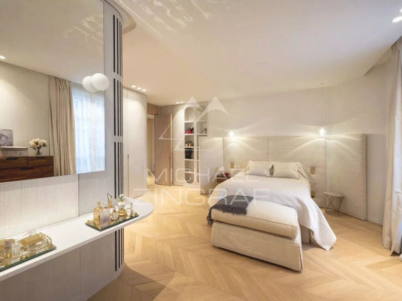 Room in a renovated apartment with parquet flooring and modern decor in Paris 7th arrondissement.