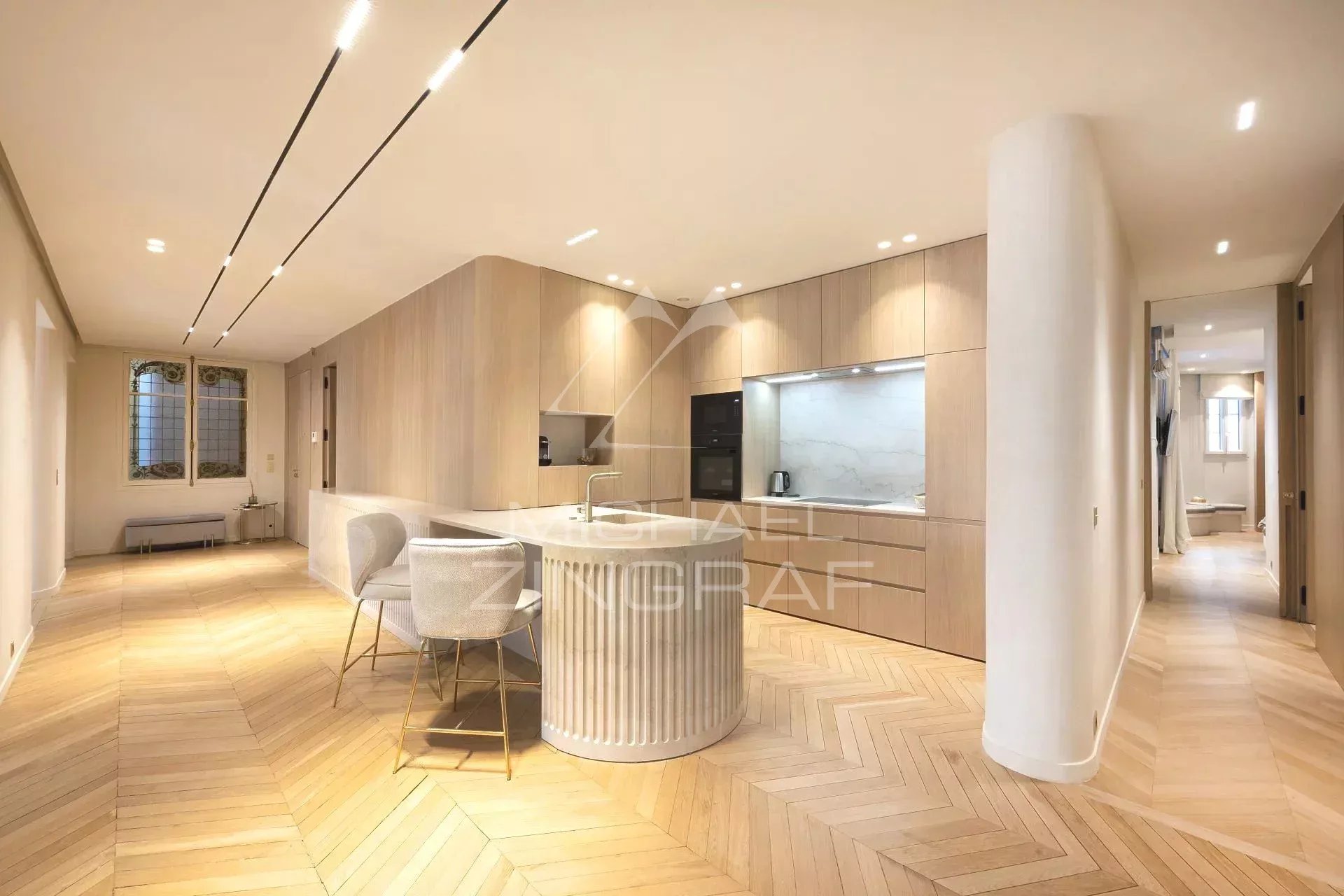 Modern apartment in Paris 7th arrondissement Interior of a modern apartment with open kitchen and wooden parquet flooring, located in Paris.