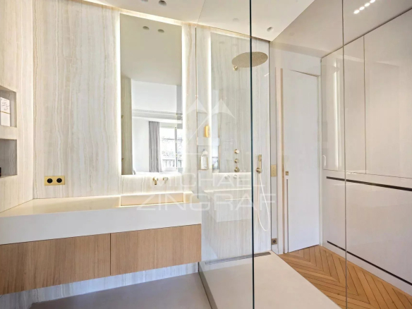 Modern bathroom with walk-in shower and wooden vanity unit.
