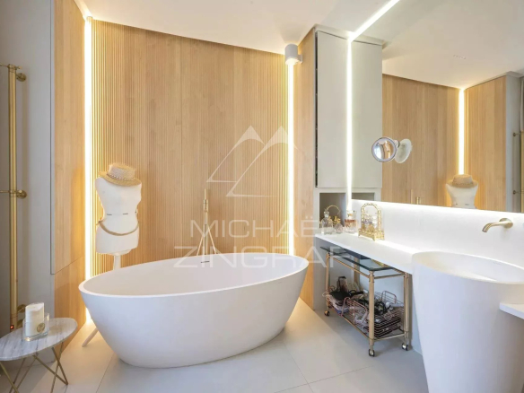 Modern bathroom with freestanding bathtub and elegant furniture.