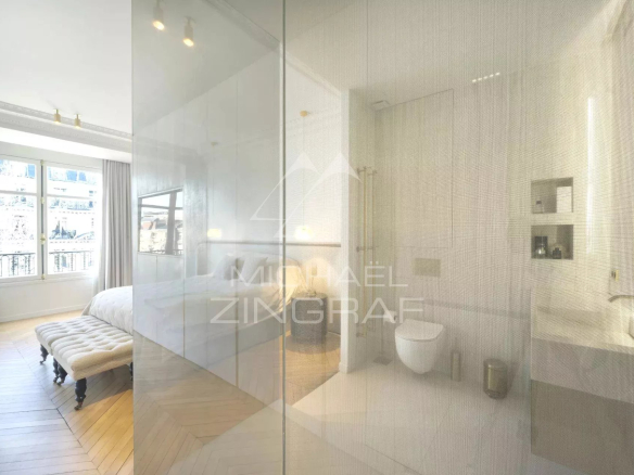 Modern bathroom with shower and toilet, overlooking a bright bedroom in Paris 7th arrondissement.