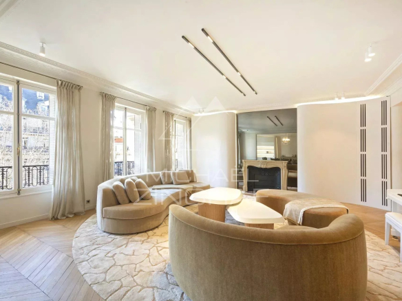 Spacious and bright living room in a renovated apartment in Paris, with windows and modern furniture.