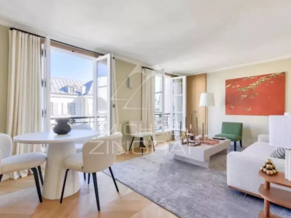 Interior of a furnished apartment in Paris, bright living room with dining table and sofa.