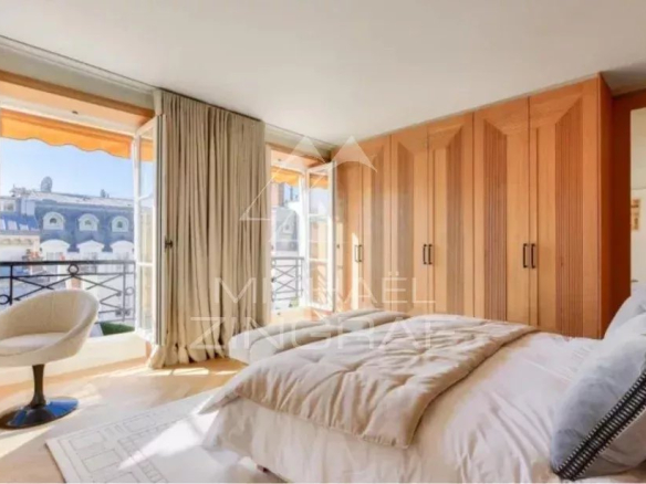 Room in a furnished apartment in Paris 7th arrondissement with unobstructed view and wooden furniture.