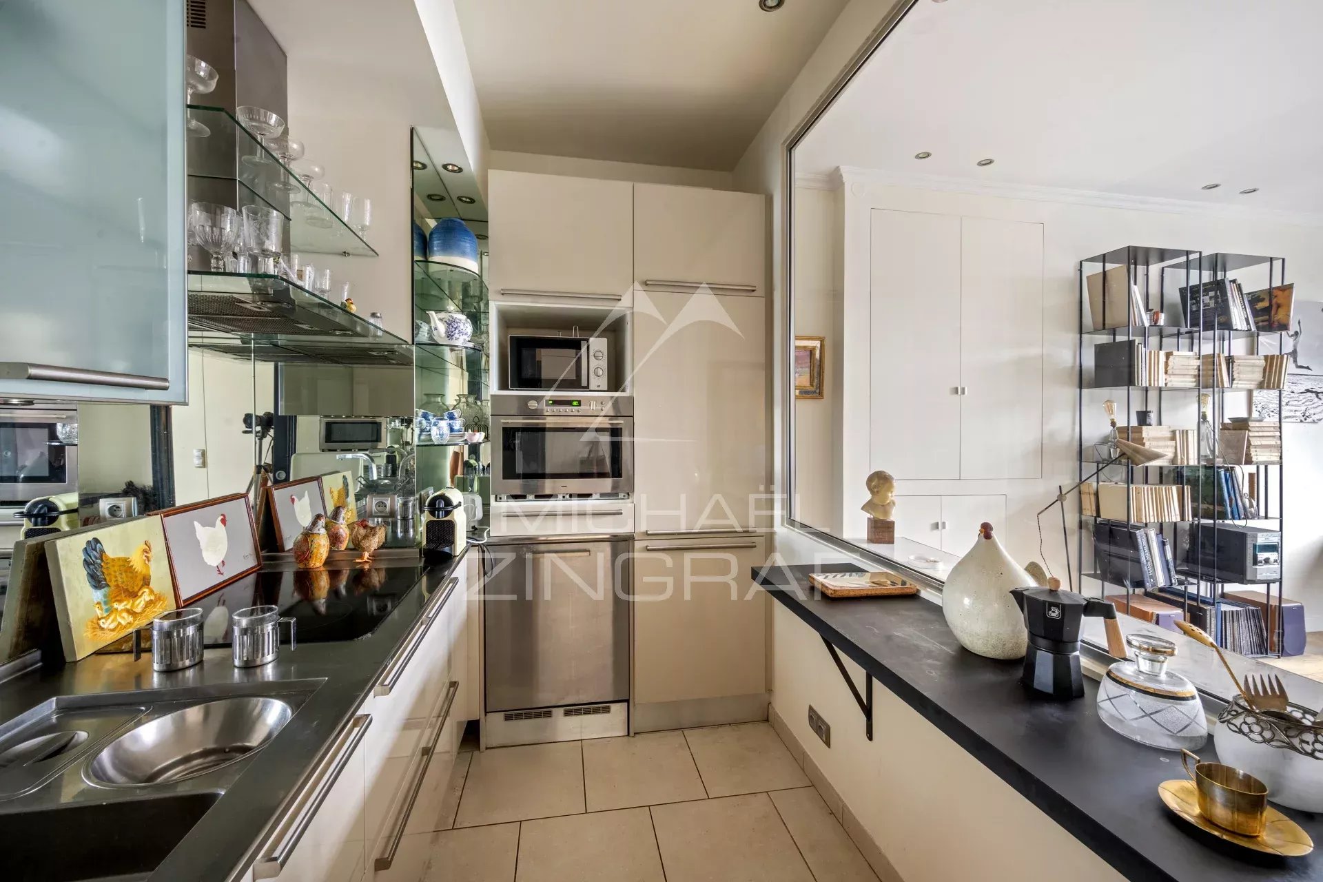 Cuisine d’un appartement à Paris IX Cuisine équipée d'un appartement à vendre, avec meubles modernes et appareils électroménagers.