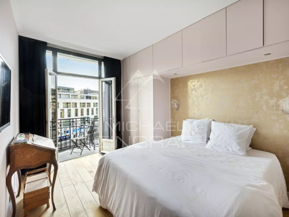 Chambre d'appartement avec lit double et balcon à Paris 9ème.
