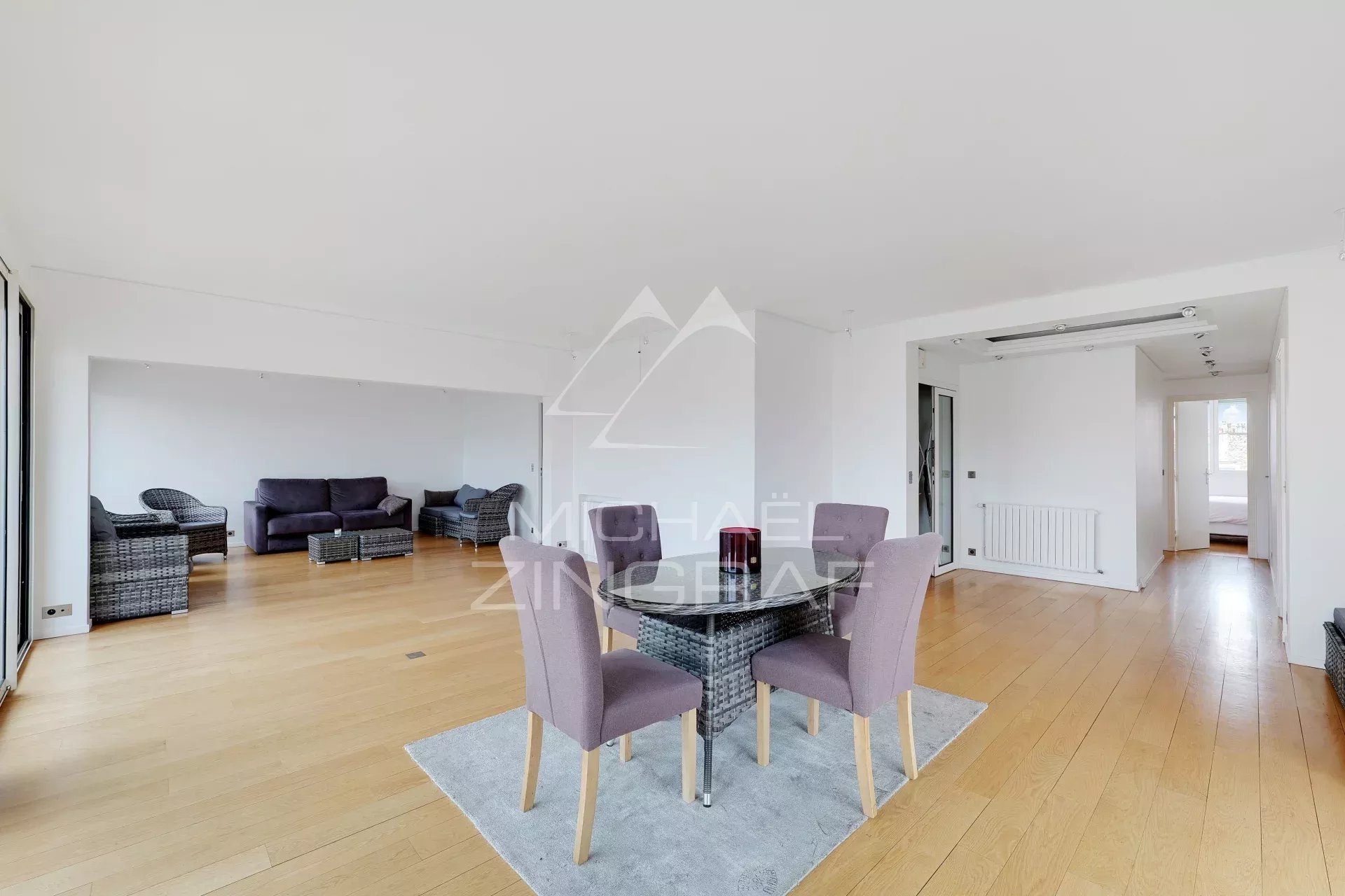 Appartement à vendre à Paris 6ème Intérieur d'un appartement moderne avec salon spacieux et coin repas, parquet en bois.