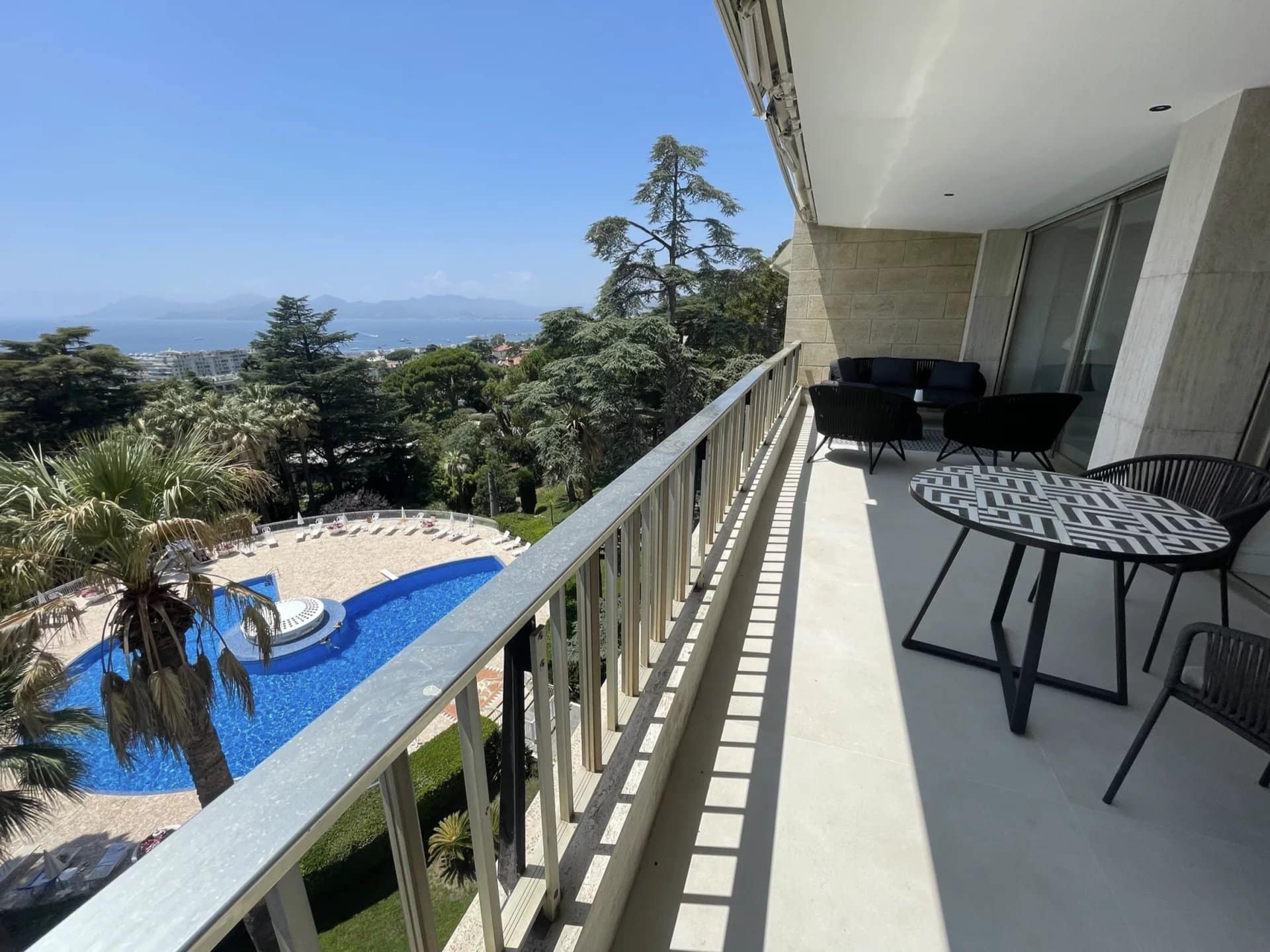 Terrace of an apartment in Cannes with sea and pool views.