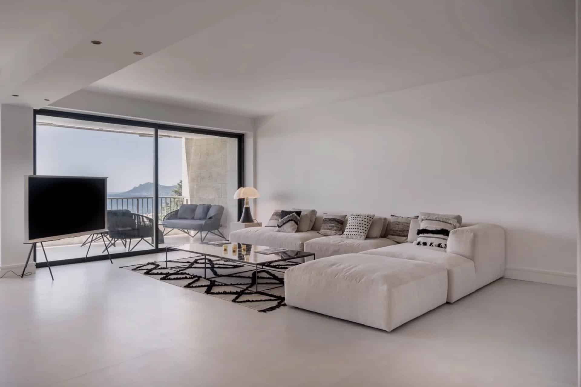 Interior of a modern apartment with a spacious living room and sea view in Cannes.