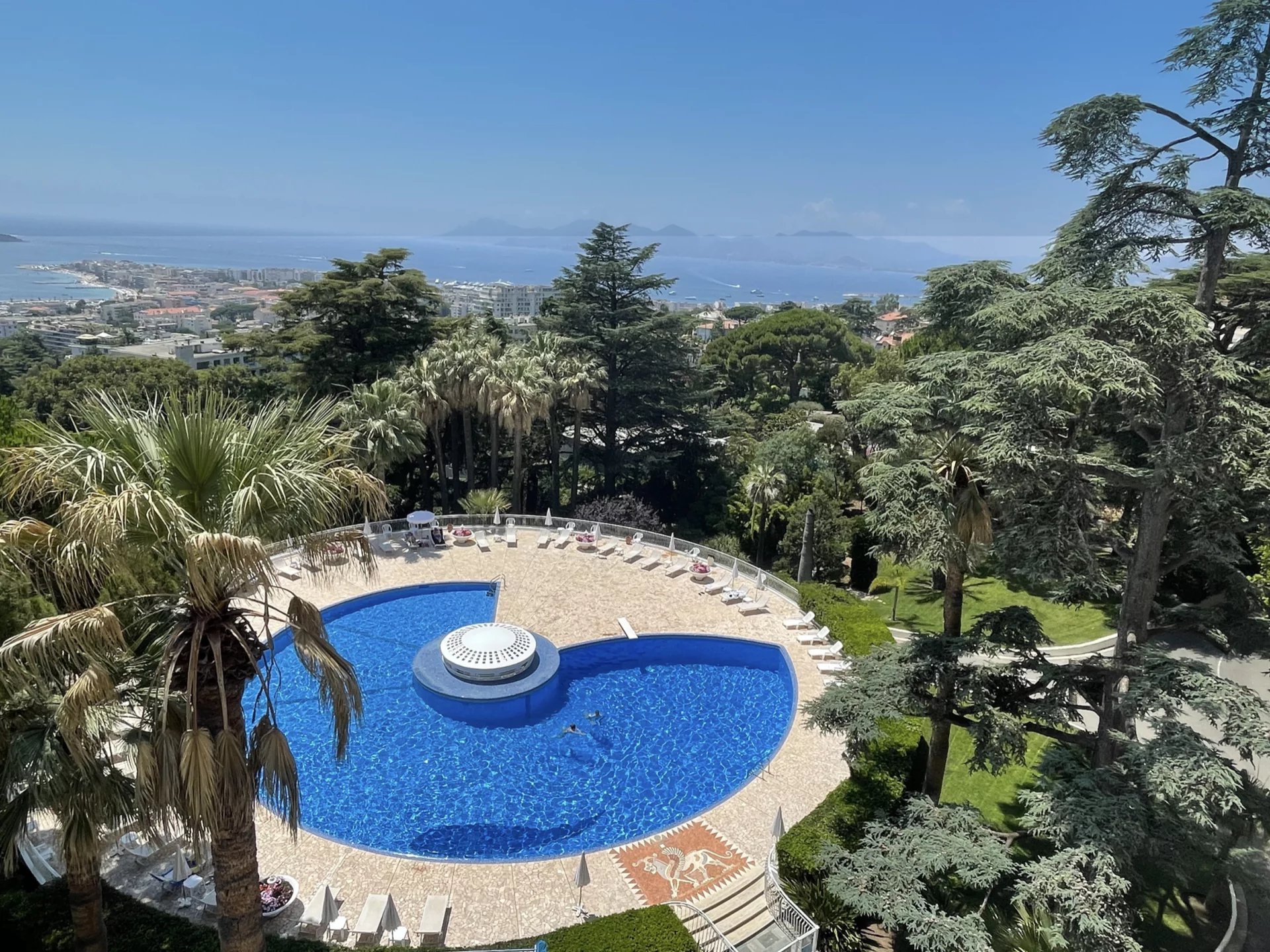 Panoramic sea view from an apartment in Cannes, with swimming pool and gardens.