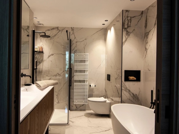 Modern bathroom with marble, bathtub and walk-in shower