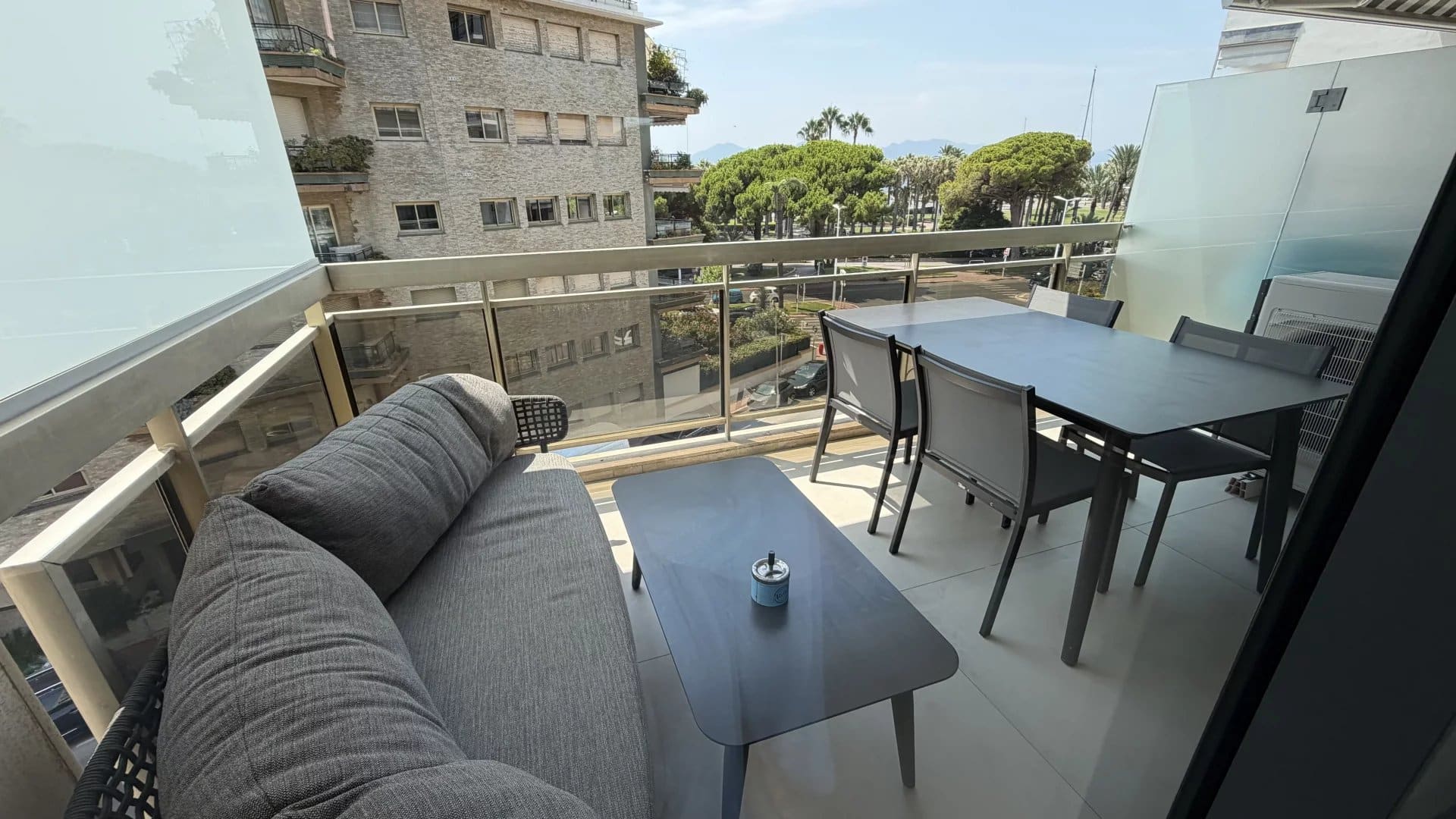 Bright terrace in Palm Beach, Cannes Apartment terrace in Cannes with outdoor furniture and a view of the Palm Beach district.