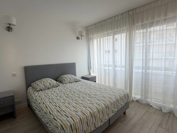 Room in a bright apartment with a double bed and sheer curtains in Cannes.