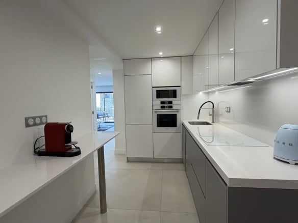 Modern and bright kitchen in an apartment in Cannes, with integrated appliances.