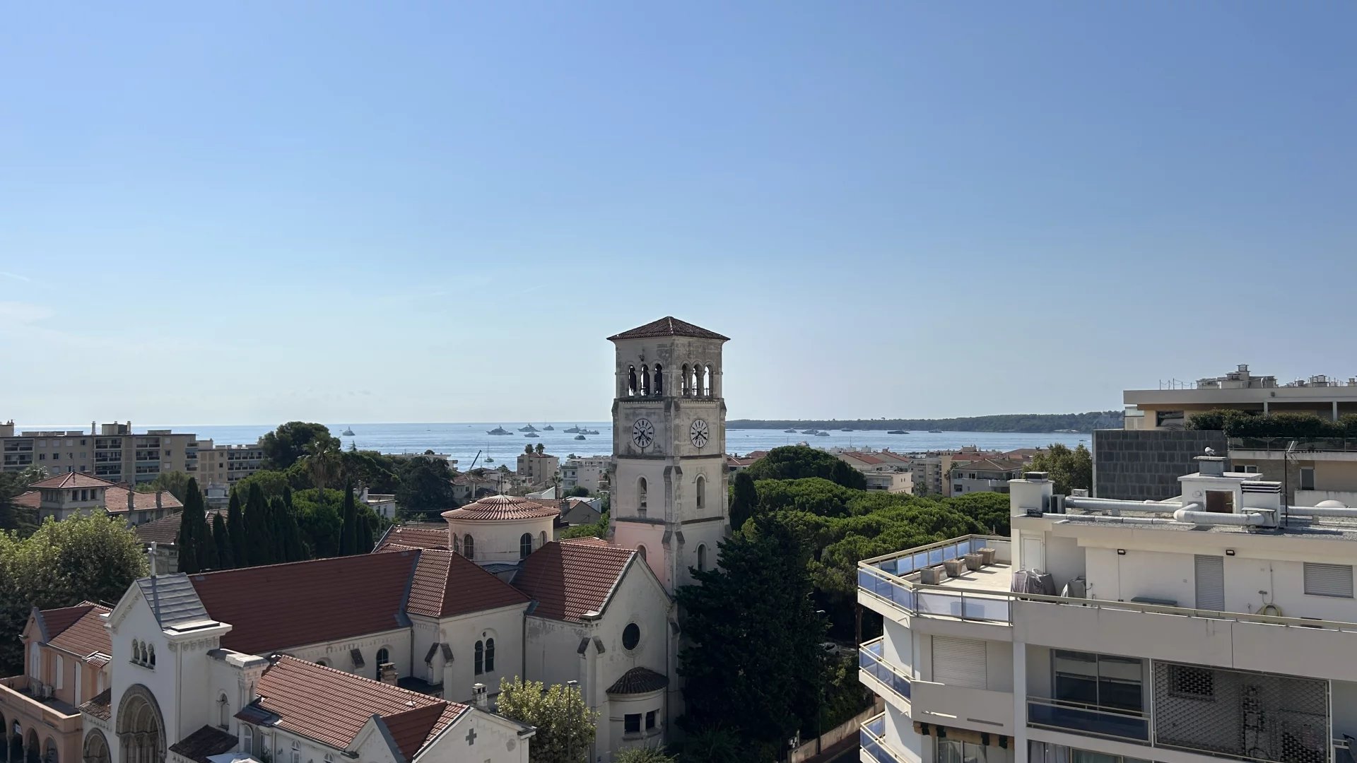 Sea view from Cannes, Baja California Sea view from a terrace in Cannes, with buildings and a church in the foreground.