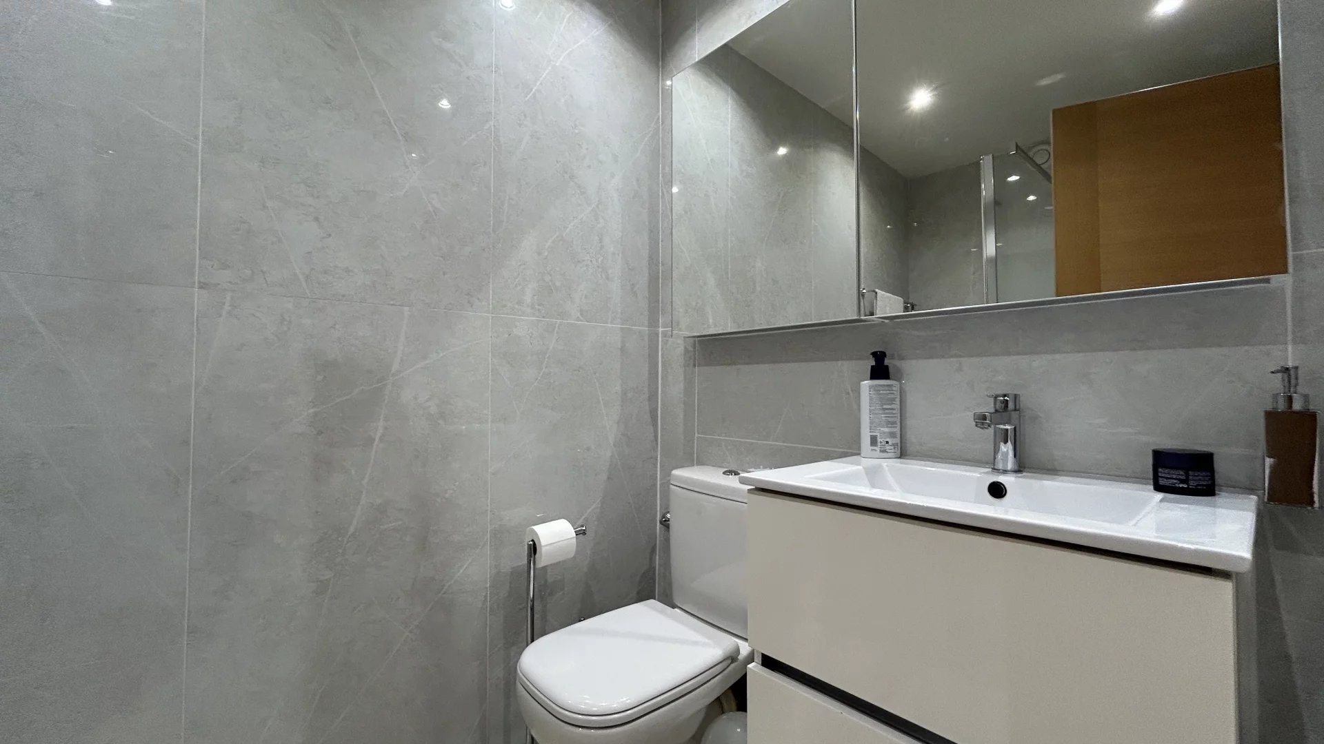 Modern bathroom Modern bathroom with grey tiles, sink and mirror.