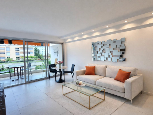 Interior of a modern apartment in Cannes with a bright living room and a terrace.