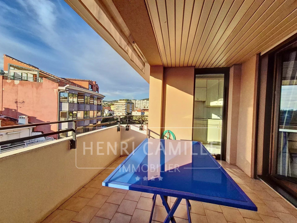 Terrasse avec vue depuis un appartement en duplex à Cannes, dernier étage, mobilier de jardin visible.