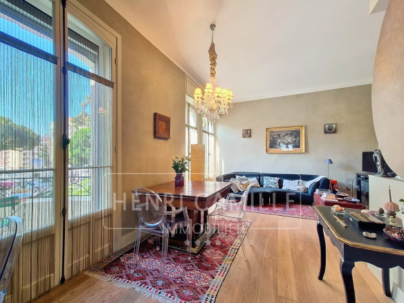 Interior of an apartment in Cannes with living room, dining table and sofa.