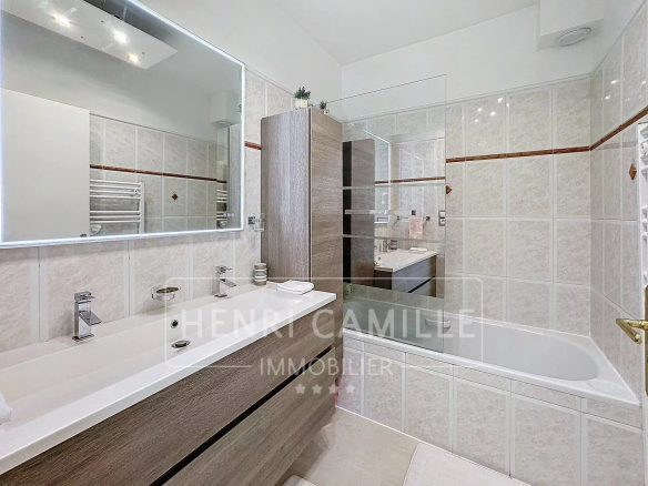 Salle de bain moderne avec meubles en bois et miroir lumineux