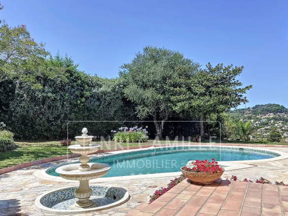 Panoramic view of a villa with pool and garden in Supercannes, Cannes.