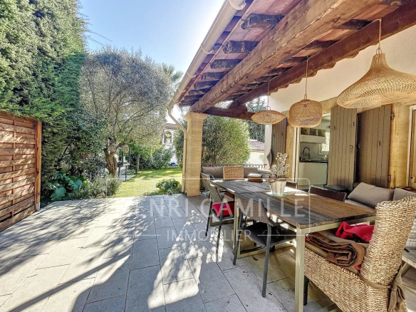Terrace of a villa with outdoor furniture in a landscaped garden in Cannes Petit Juas.