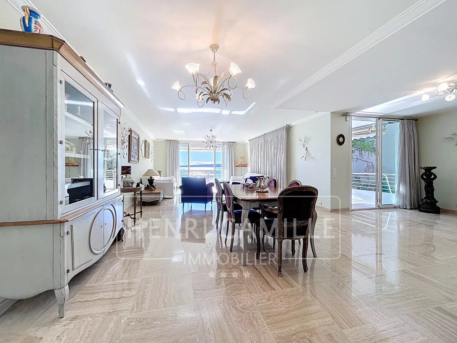 Intérieur d'un appartement spacieux à Cannes avec vue sur la mer, mobilier moderne et lumière naturelle.