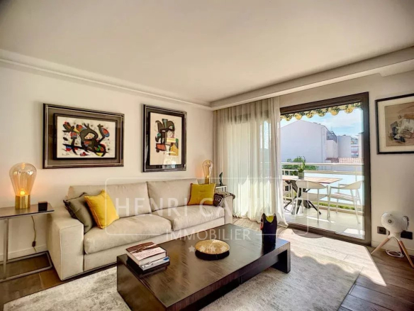 Living room of a renovated apartment with terrace in Cannes, modern and bright furniture.