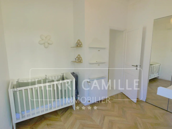 Children's room with a baby bed and minimalist decor.